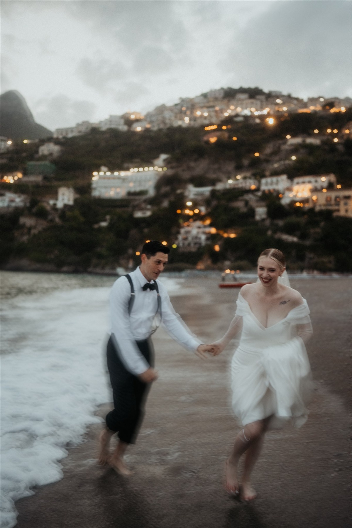 Jess and Corey celebrating their vow renewal on the beach in Positano
